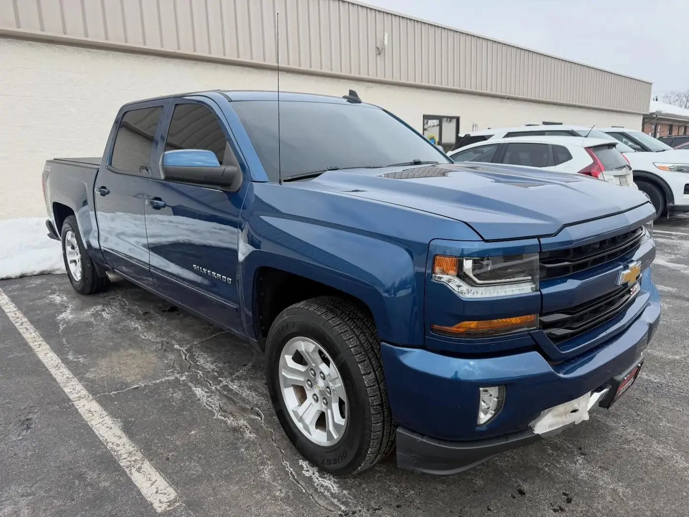 Blue Chevrolet Silverado with tinted cab windows