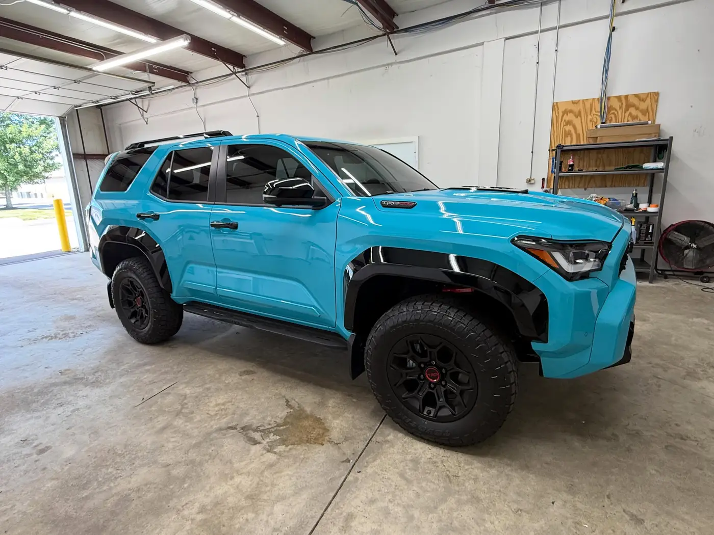 Blue Toyota 4Runner in the clean indoor install bay at Tint-Factory on N Dixie Dr