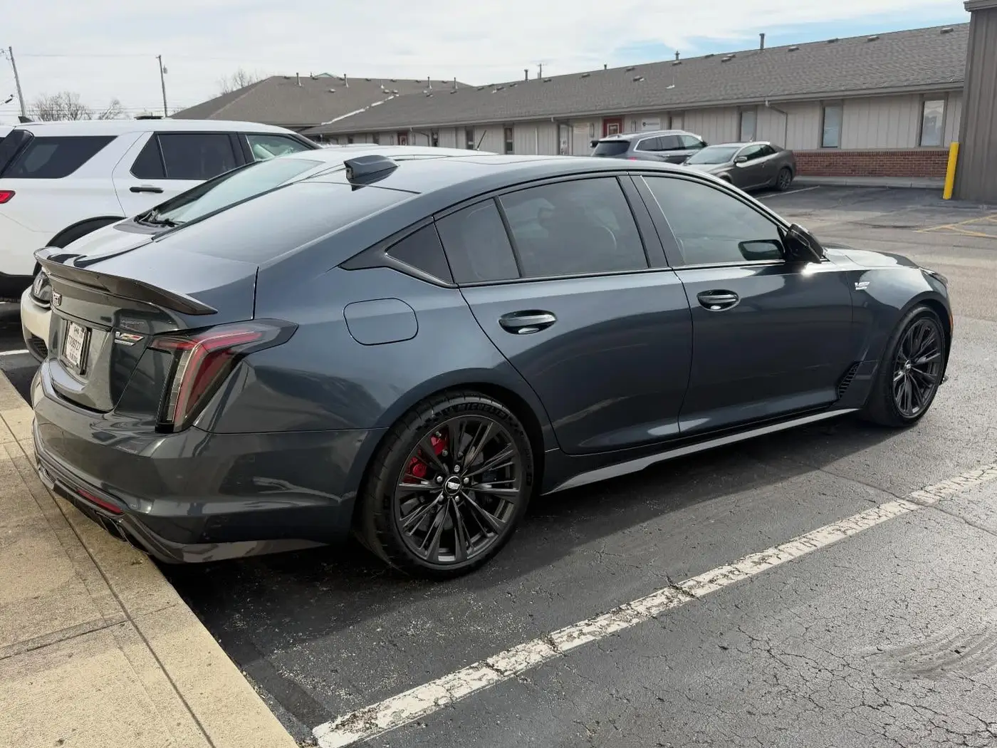 Gray Cadillac CT5-V with dark tint, rear three quarter view