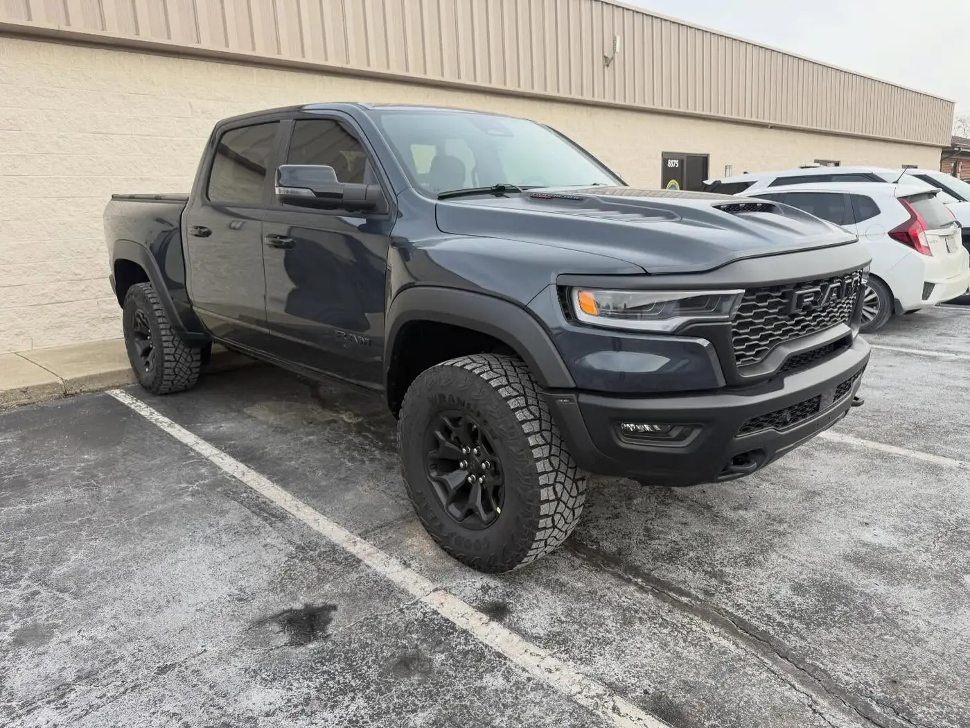Gray Ram TRX pickup with tinted windows in the lot