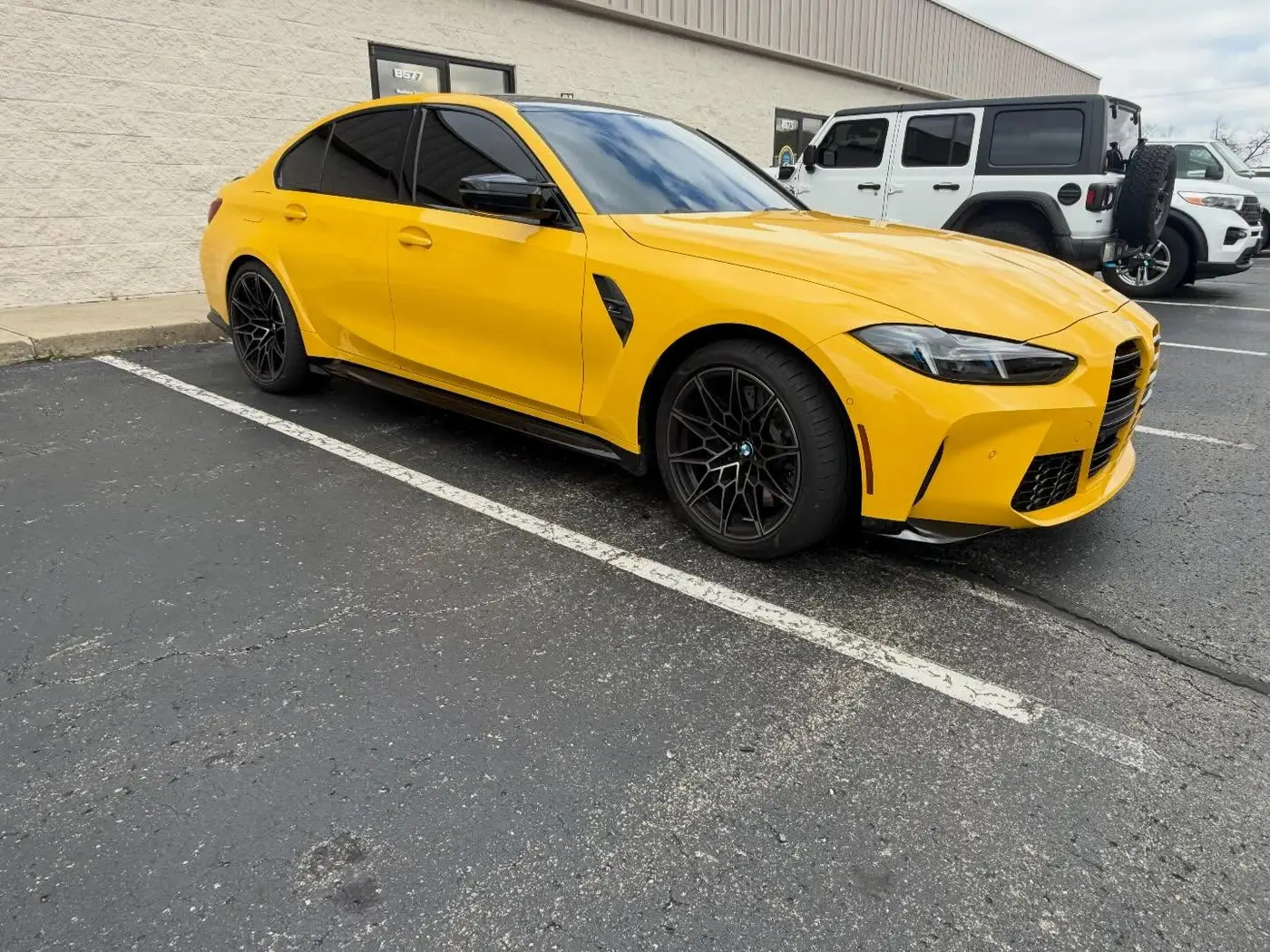 Yellow BMW M3 front end protected with clear bra paint protection film